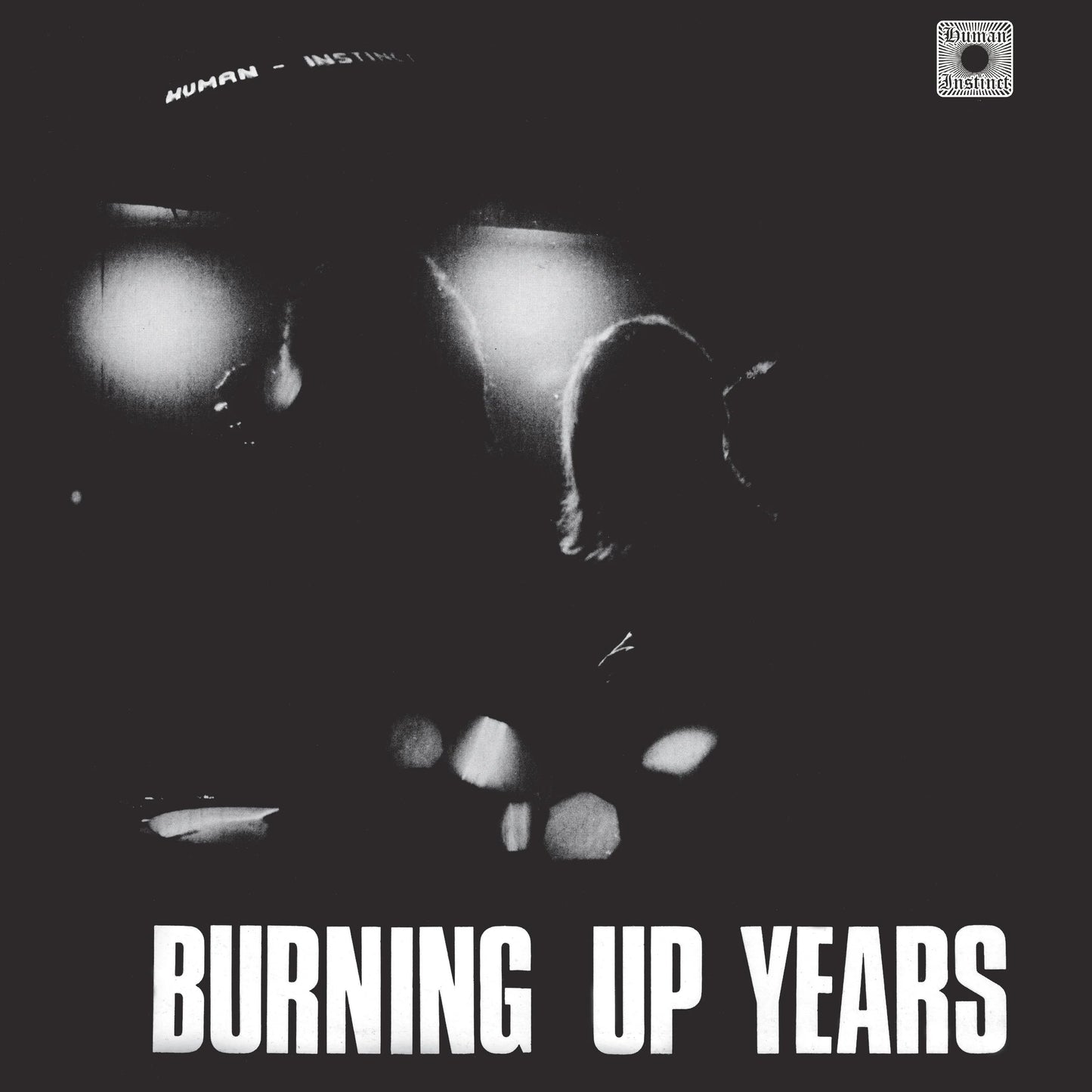 Album cover with silhouette of a person and text 'Burning Up Years' on a dark background