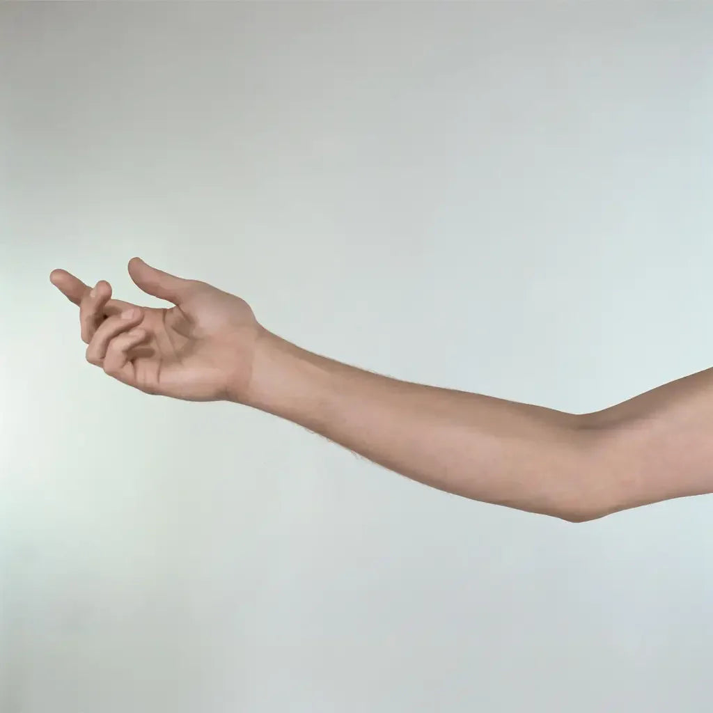 Arm and hand making a gesture against a plain background