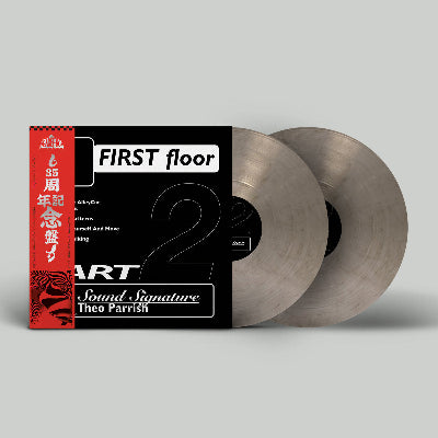 Vinyl records with a red and black cover on a gray background